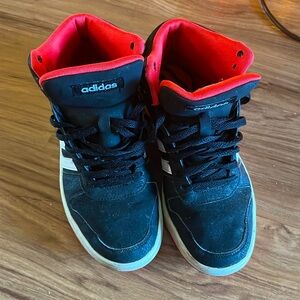 Black adidas high tops with red interior